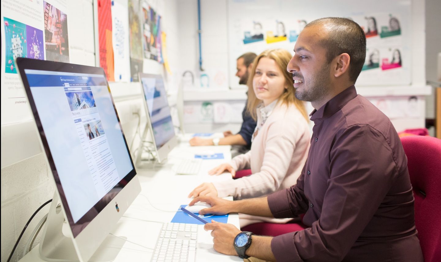 Students studying in Mac lab at Glasgow Caledonian University