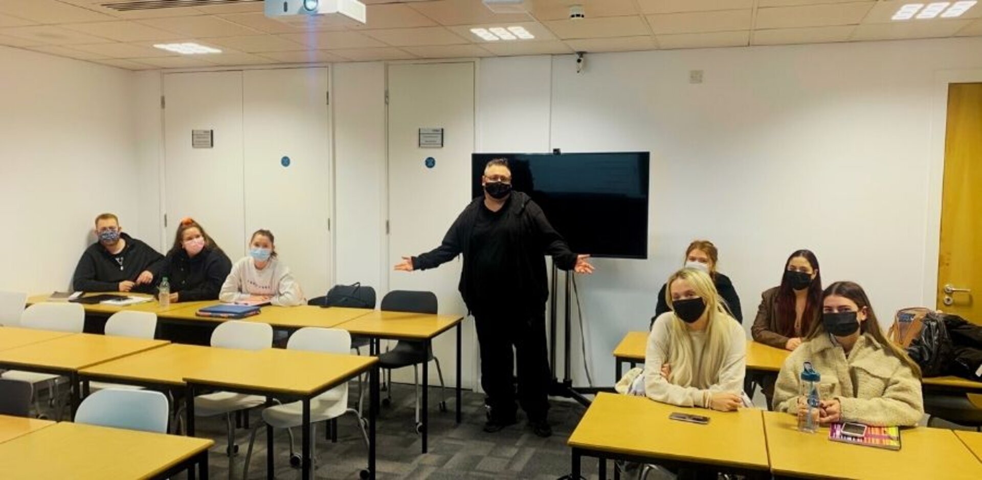 Chrissy in his classroom with students during first week of teaching.