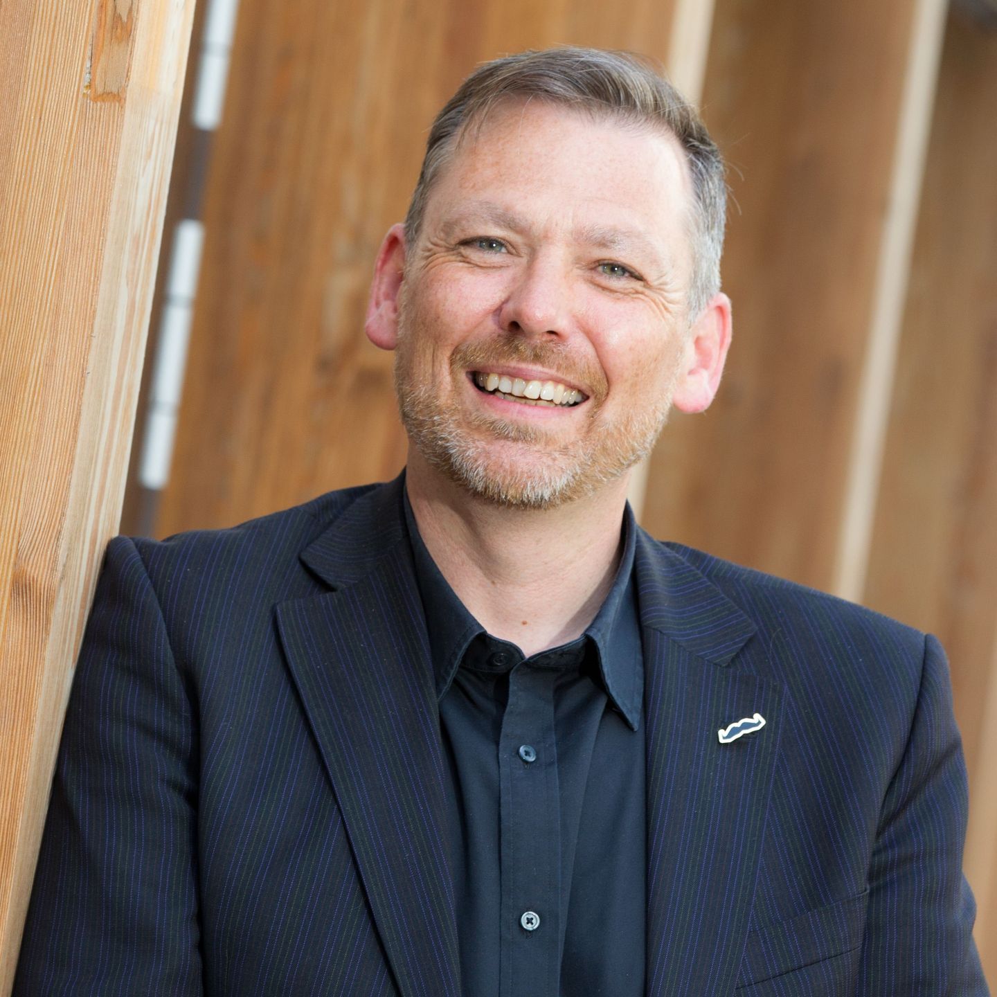 An image of Owen Sharp, a GCU alumnus and Chief Executive of Dog's Trust, smiling.