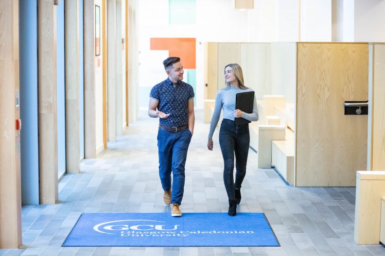 Two BA (Hons) International Business students walking on Glasgow campus in November 2018.