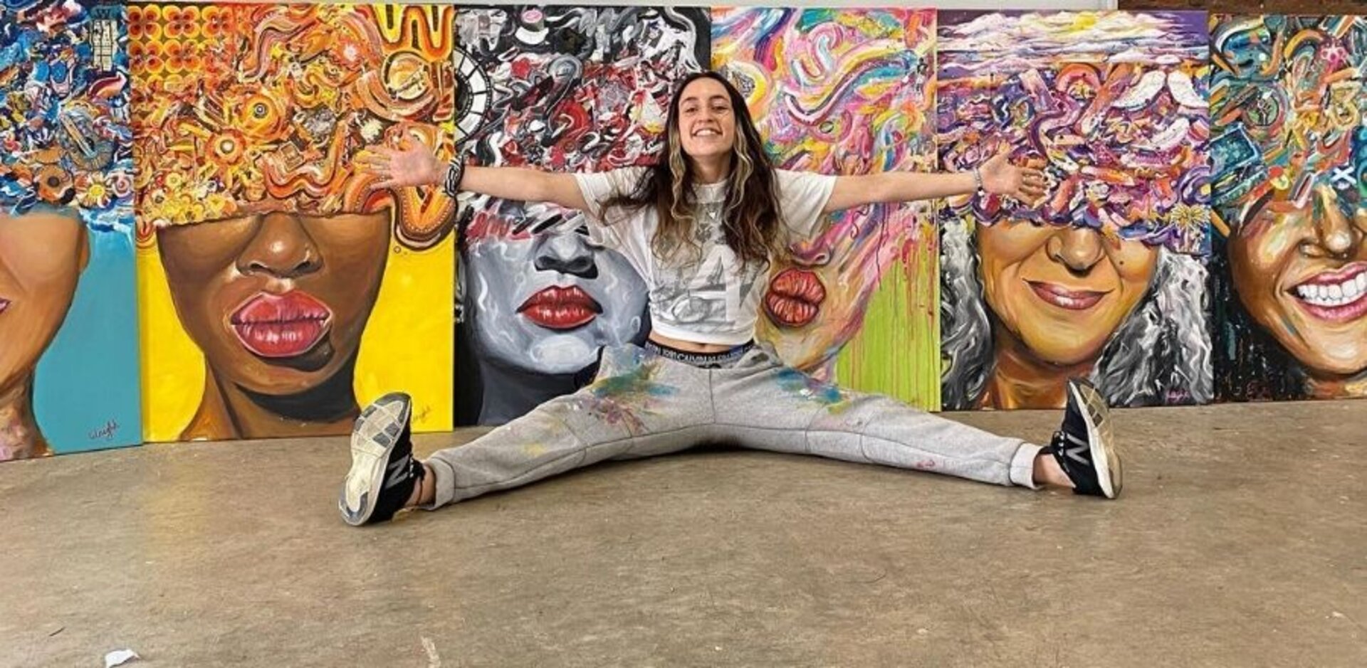 Karis Knight at her studio with collection of her paintings