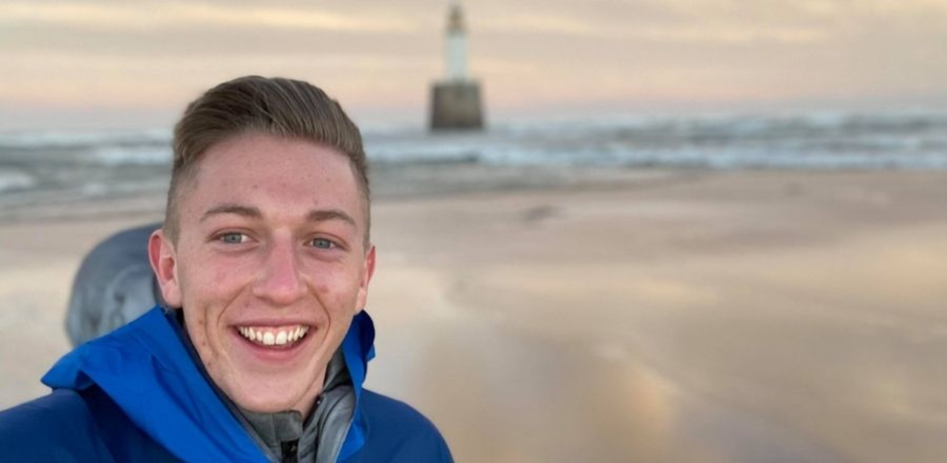 (pictured above) Marcus standing on a beach