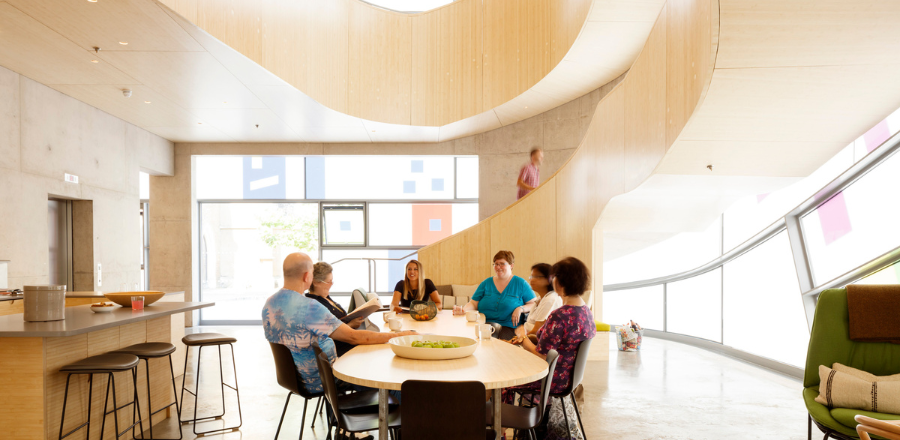 Photo of Maggie’s visitors chatting around a table, taken by Phillip Durrant