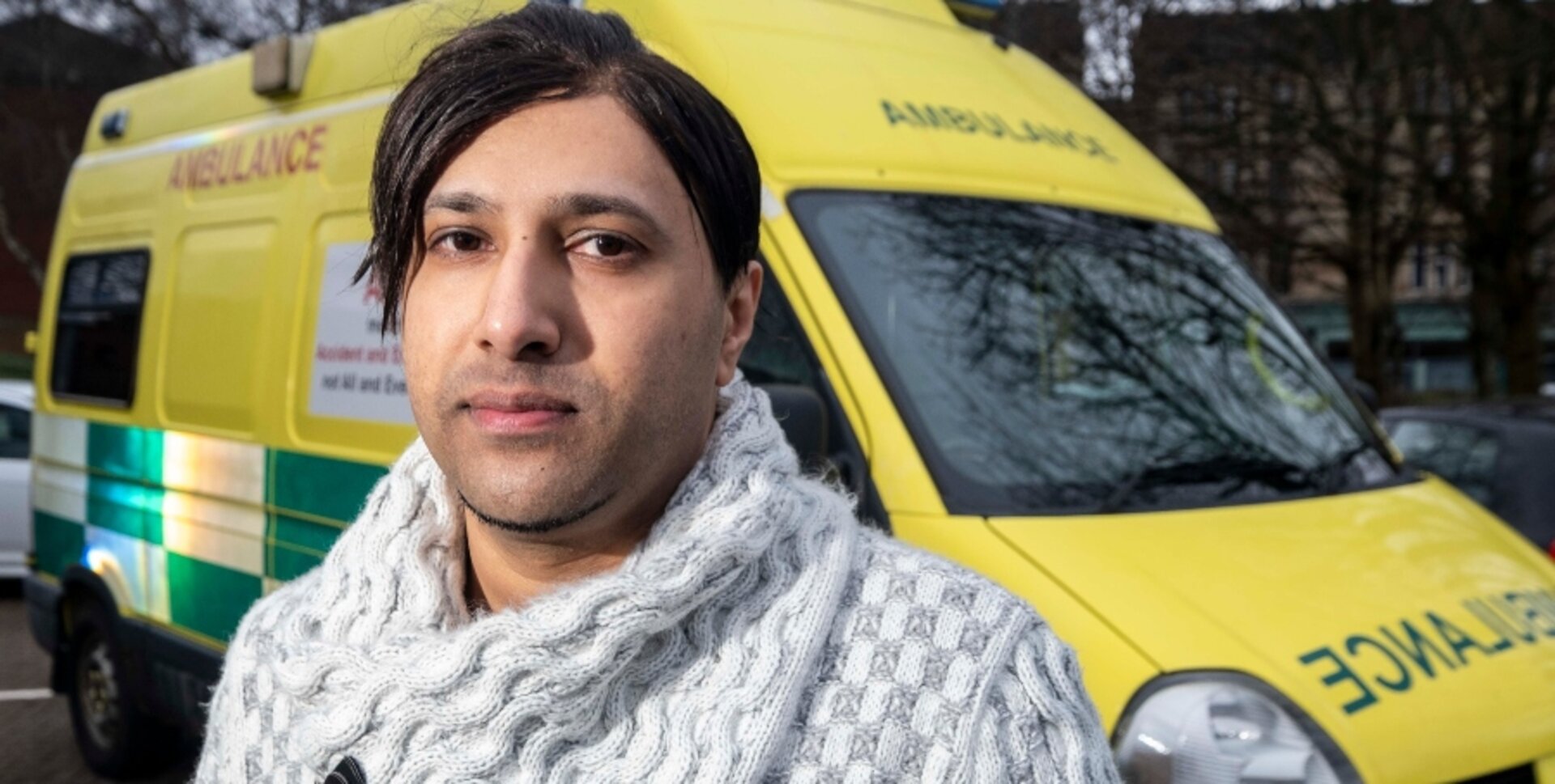 Umran Ali standing in front of an ambulance 