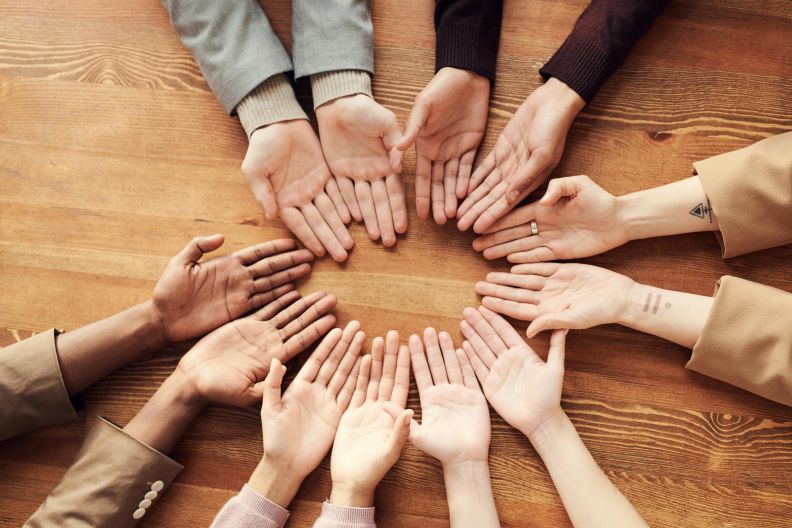 Image of hands joing together in a circle