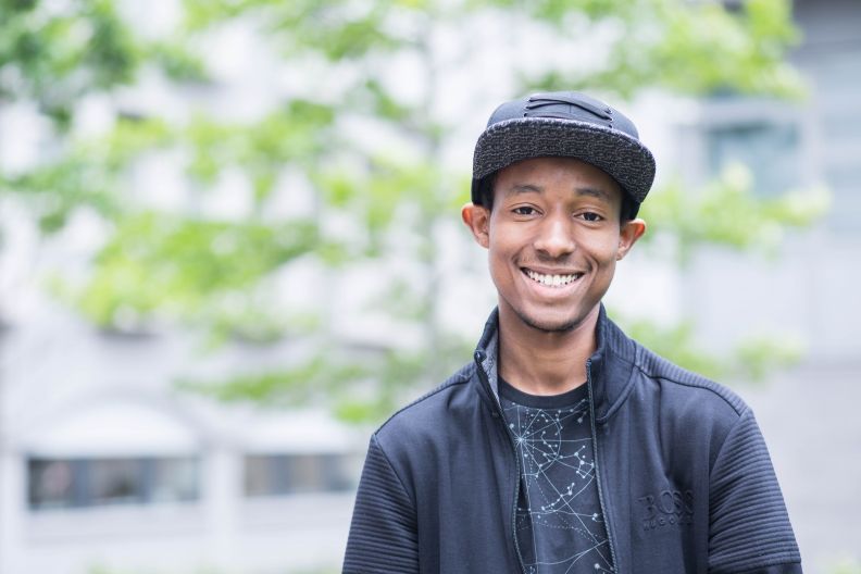 Student with baseball cap on campus at Glasgow Caledonian University