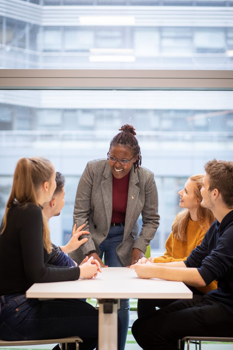 Class Representative talking to a group of students around a table