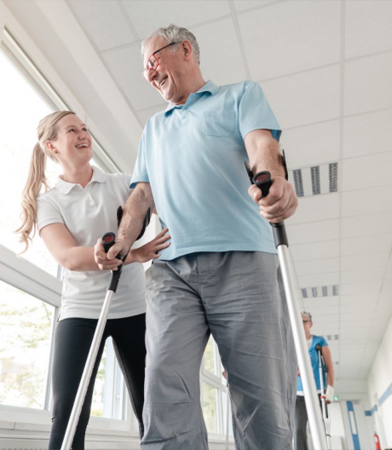 Nursing student assisting a patient to walk